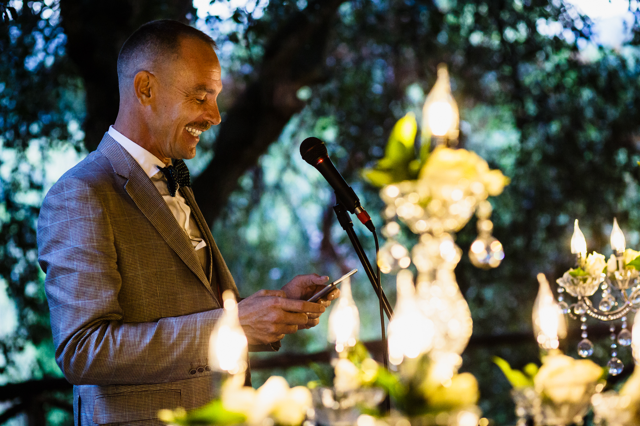 A man speaks into a microphone during an evening reception toast