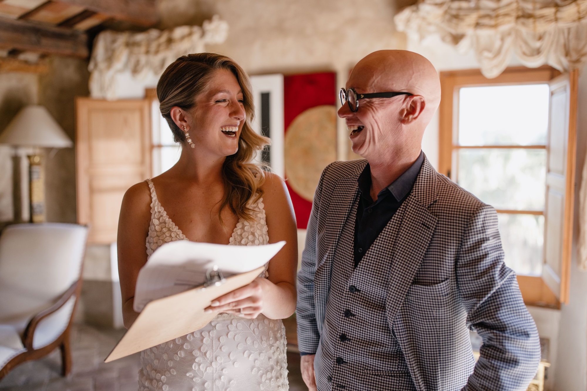 salvador-costa-wedding-planner-laughing-with-bride-barcelona Salvador of Costa & Mason laughing with a bride as they go through the day's running order